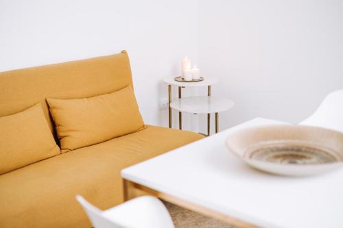 a living room with a yellow couch and a table at Suite1212 - Pirrelli in Monopoli