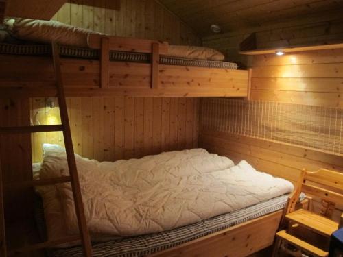 a bedroom with two bunk beds in a cabin at Svarthamar - cabin with amazing view in Al