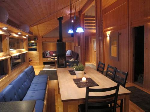 a living room with a table and a blue couch at Svarthamar - cabin with amazing view in Ål