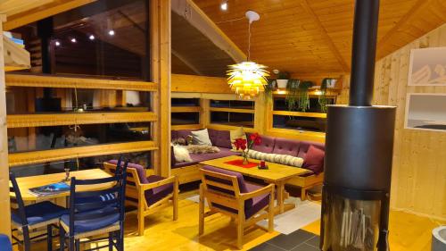 a restaurant with a fireplace and a table and chairs at Svarthamar - cabin with amazing view in Ål