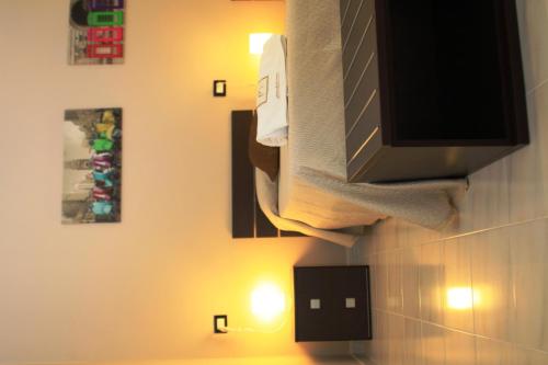 a bathroom with a tv and some pictures on the wall at B&B Tra Monti e Mare in Ogliastro Cilento