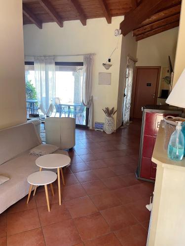 a living room with a couch and tables at Donnigheddu in Rudalza