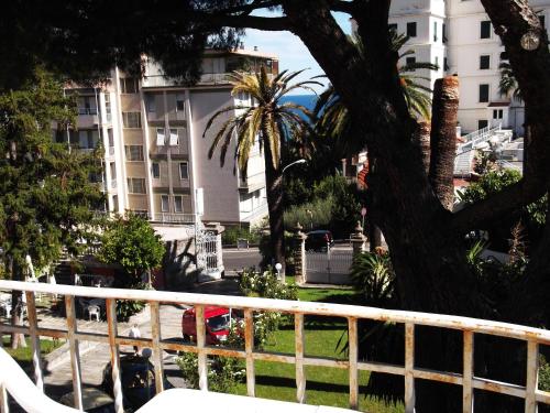 a view from a balcony of a building with a palm tree at Hotel Villa Maria in Sanremo