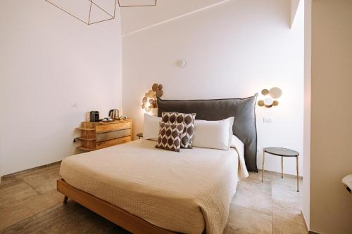 a bedroom with a large bed and a table at Suite1212 - Pirrelli in Monopoli