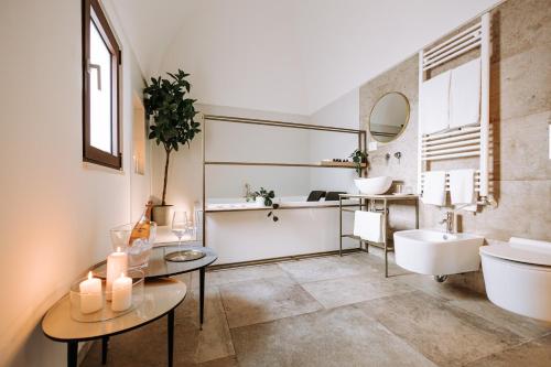 a bathroom with a sink and a toilet and a mirror at Suite1212 - Pirrelli in Monopoli