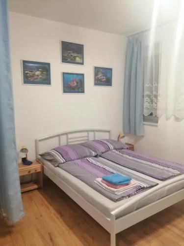a bedroom with a bed with purple pillows at Ubytování Eva in Luhačovice