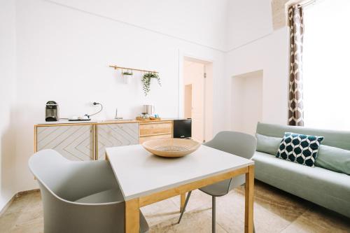 a living room with a table and a couch at Suite1212 - Pirrelli in Monopoli