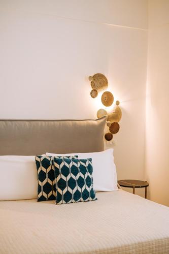 a bed with two pillows on top of it at Suite1212 - Pirrelli in Monopoli