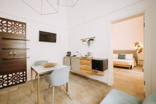 a white living room with a table and a tv at Suite1212 - Pirrelli in Monopoli