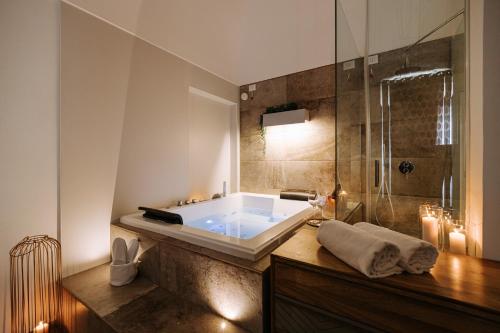 a bathroom with a large tub and a shower at Suite1212 - Pirrelli in Monopoli