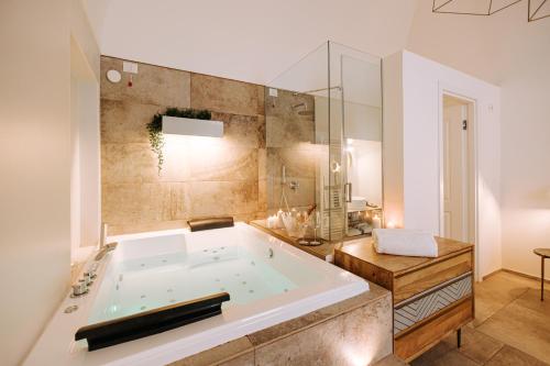 a bathroom with a large tub in a room at Suite1212 - Pirrelli in Monopoli