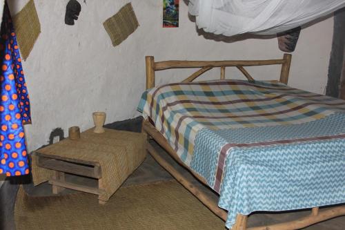 Ένα ή περισσότερα κρεβάτια σε δωμάτιο στο Red Rocks Rwanda - Campsite & Guesthouse