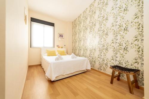 a bedroom with a white bed and a window at -MalagaSunApts- Stylish City Centre Pool&Parking in Málaga