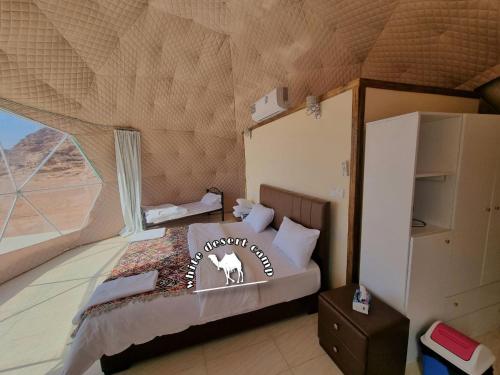 a bedroom with a bed in a tent at White Desert Camp in Wadi Rum