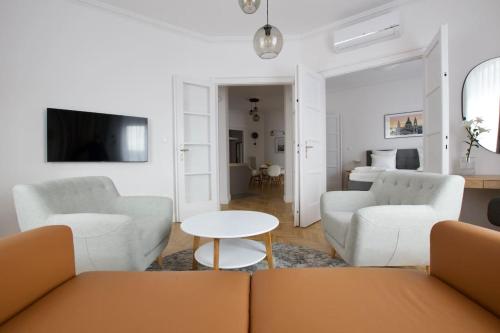 a living room with a couch and a table at Premium Apartment by Hi - Central 2 BR - best view in Budapest