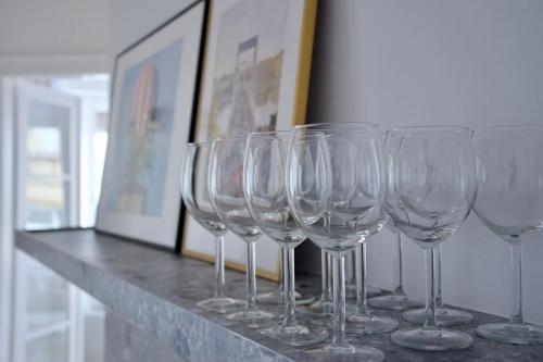a row of wine glasses sitting on a counter at Premium Apartment by Hi - Central 2 BR - best view in Budapest