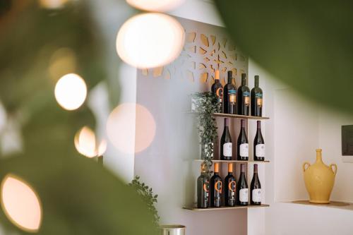 a bunch of wine bottles on a shelf in a room at Suite1212 - Pirrelli in Monopoli