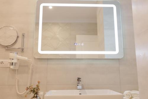 a bathroom with a sink and a mirror at Muller Hotel Boutique & Spa in Galaţi