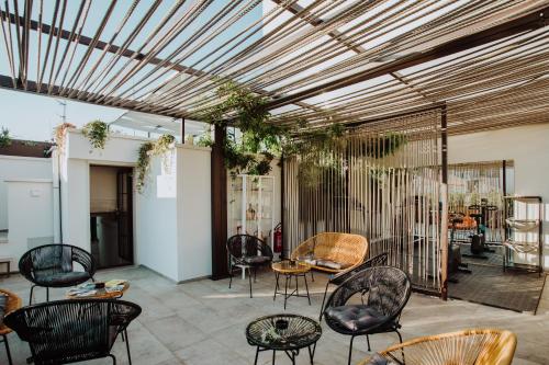 a patio with chairs and tables in a room at Suite1212 - Pirrelli in Monopoli