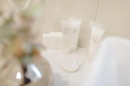 a bathroom counter with a sink and some toiletries at Muller Hotel Boutique & Spa in Galaţi