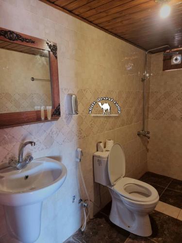 a bathroom with a toilet and a sink at White Desert Camp in Wadi Rum