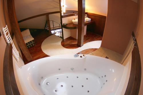 a bath tub in the middle of a bathroom at Krakow Jacuzzi Apartment in Krakow