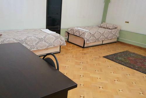 a room with two beds and a wooden floor at Royal Boutique Hotel on Kievyan in Yerevan