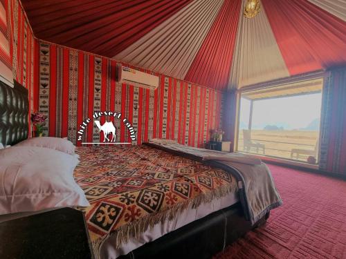 a bedroom with a bed in a tent at White Desert Camp in Wadi Rum