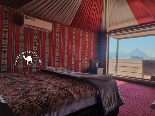 a bedroom with a bed with a cow on the wall at White Desert Camp in Wadi Rum