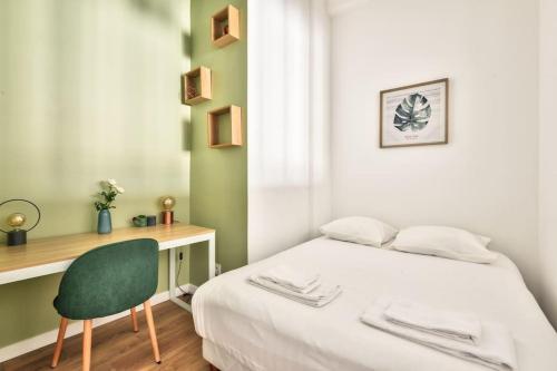 a bedroom with a bed and a desk and a chair at Magnificent apartment - Carré d'or in Nice
