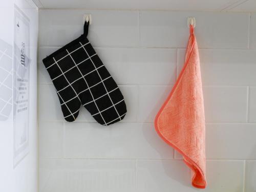 two black and white towels hanging on a wall at Lavish Beacon Executive Suites by Bin Dao Wu Homestay Penang in George Town