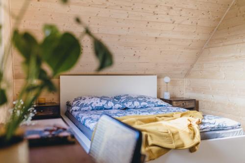 a bedroom with a bed in a room at LasHouse - Nowoczesna stodoła z widokiem na las in Bronków