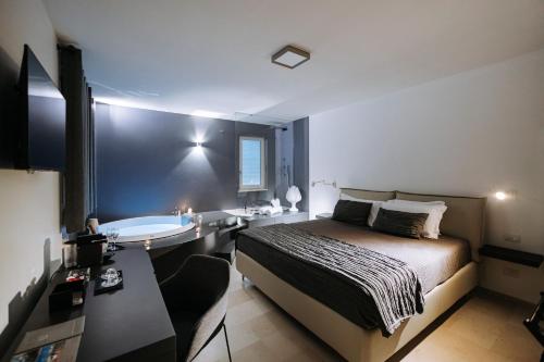 a bedroom with a bed and a bath tub in it at Suite1212 - Rattazzi in Monopoli