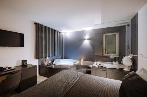 a bedroom with a bed and a tub and a sink at Suite1212 - Rattazzi in Monopoli