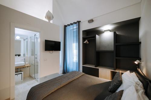 a bedroom with a large bed and a bathroom at Suite1212 - Rattazzi in Monopoli