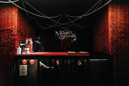 a bar with a red counter in a room at Masoch. Hotel & Cafe in Lviv