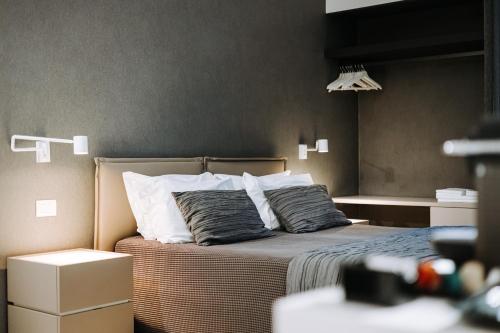 a bedroom with a bed with two pillows on it at Suite1212 - Rattazzi in Monopoli