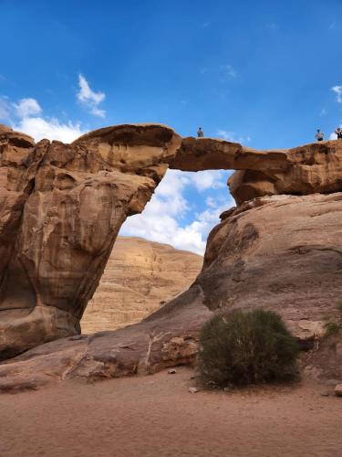 an arch in a rock formation in the desert at White Desert Camp in Wadi Rum