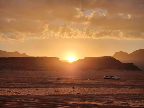 a car parked in the desert at sunset at White Desert Camp in Wadi Rum