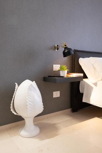 a room with a white lamp and a shelf on the wall at Suite1212 - Rattazzi in Monopoli