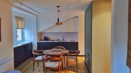 a kitchen and dining room with a table and chairs at Modern Mountain in Kolašin