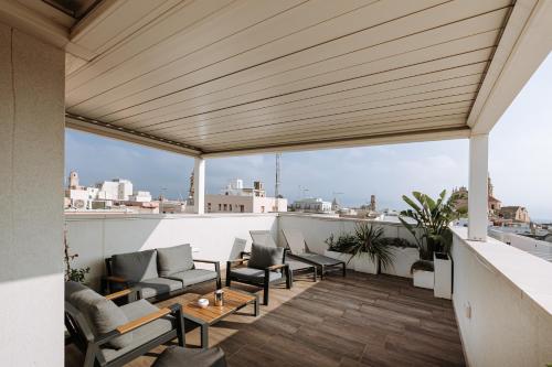 a balcony with furniture and a view of the city at Suite1212 - Rattazzi in Monopoli