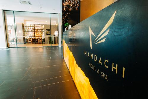 a sign for a madagascan store in a building at Mandachi Hotel & SPA in Suceava