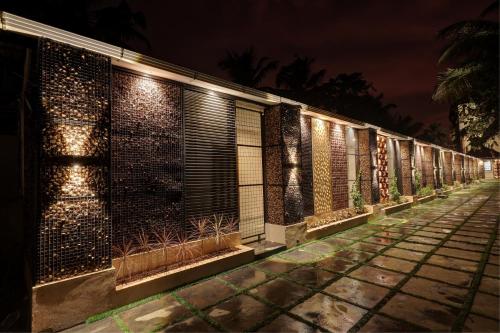 a row of lights on a building at night at Kumarakom Park Resort in Kumarakom