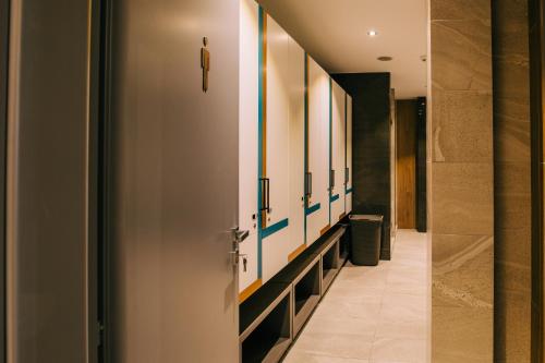 a hallway with a row of bathroom stalls at Mandachi Hotel & SPA in Suceava