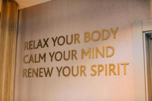 a sign that says relax your body can your mind renew your spirit at Mandachi Hotel & SPA in Suceava