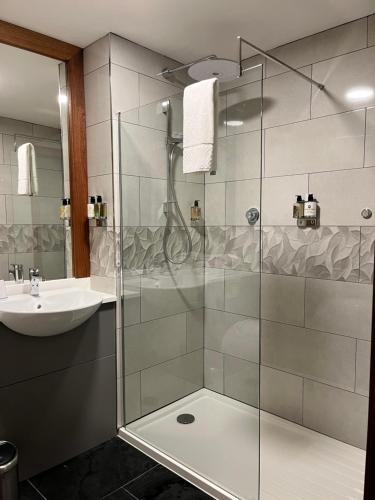 a bathroom with a shower and a sink at The Haycock Manor Hotel in Wansford