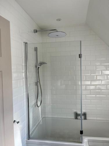 a shower with a glass door in a bathroom at The Haycock Manor Hotel in Wansford