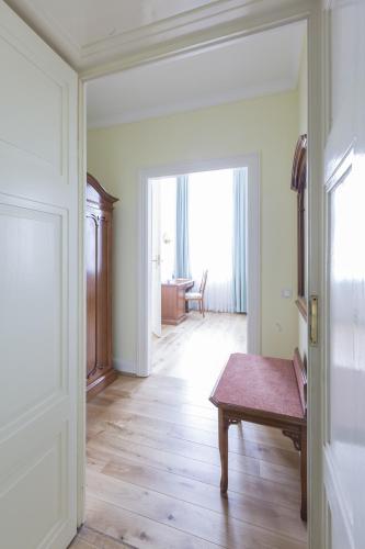 a room with a wooden floor and a wooden table at Schlosshotel Westerholt in Herten