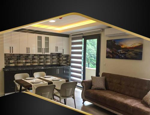 a living room with a couch and a table and chairs at GRAND ÇAYKARAM HOTEL in Çaykara